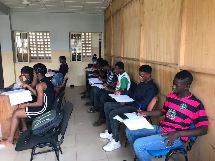 A group of students attentively participating in an educational class session indoors